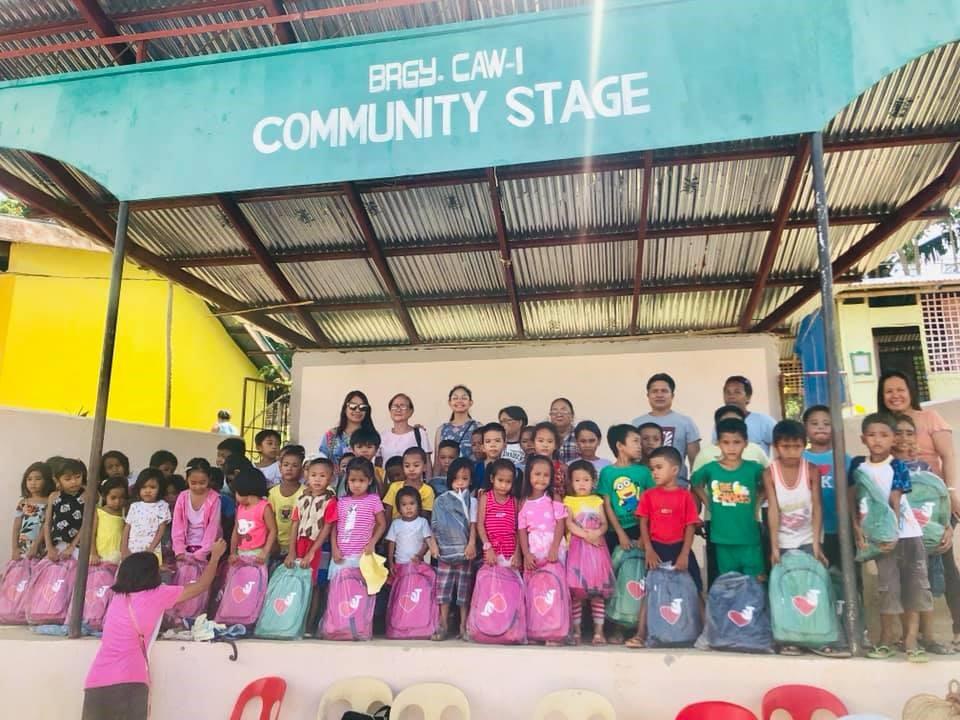 Elcad team giving out backpacks during corporate social responsibility outreach